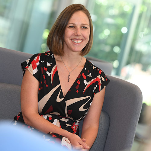 A smiling woman sitting on a couch